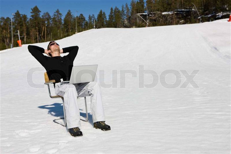 Relaxing with a laptop at Kongsberg ski center Norway, stock photo