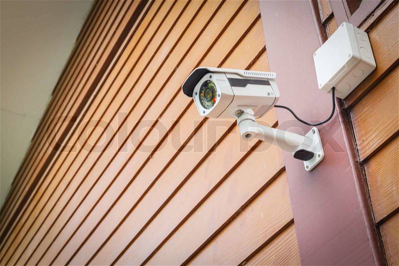 Cctv camera security on wall background for safety concept, stock photo