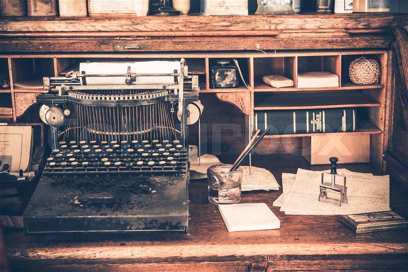 Old Desk with Vintage Typewriter. Aged Desk, stock photo