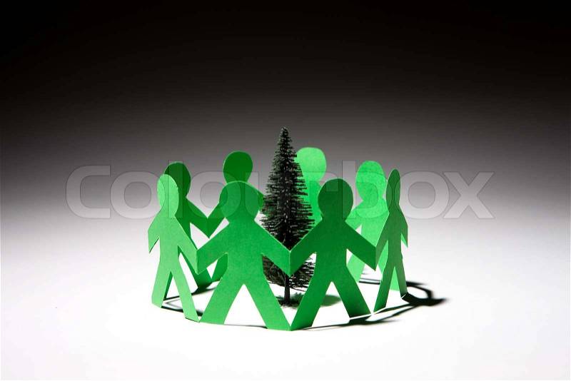 Paper cuttings of people aroind a pine tree, stock photo