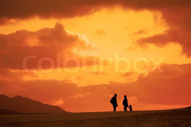 Silhouette of the family on their evening trip in the desert, stock photo
