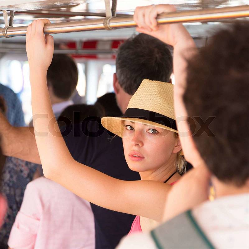 Blonde caucasian lady traveling by public transport, stock photo