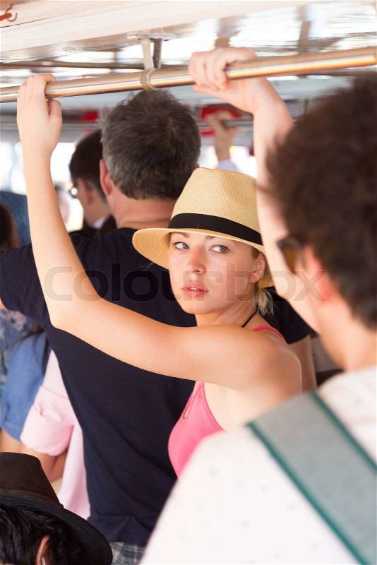 Blonde caucasian lady traveling by public transport, stock photo