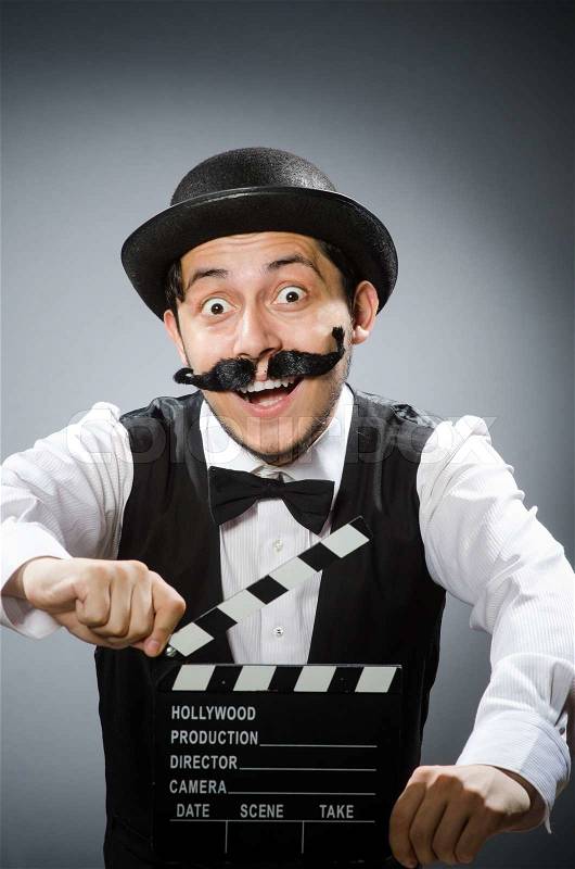 Funny man with movie clapper board , stock photo