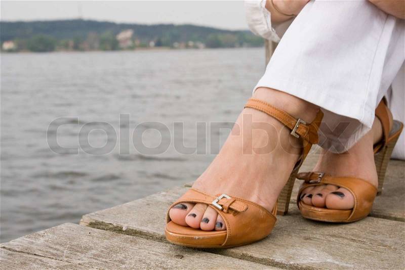 Cropped image of woman wearing sandals, stock photo