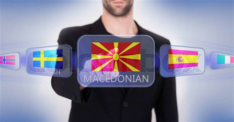 Hand pushing on a touch screen interface, choosing language or country, Macedonia, stock photo