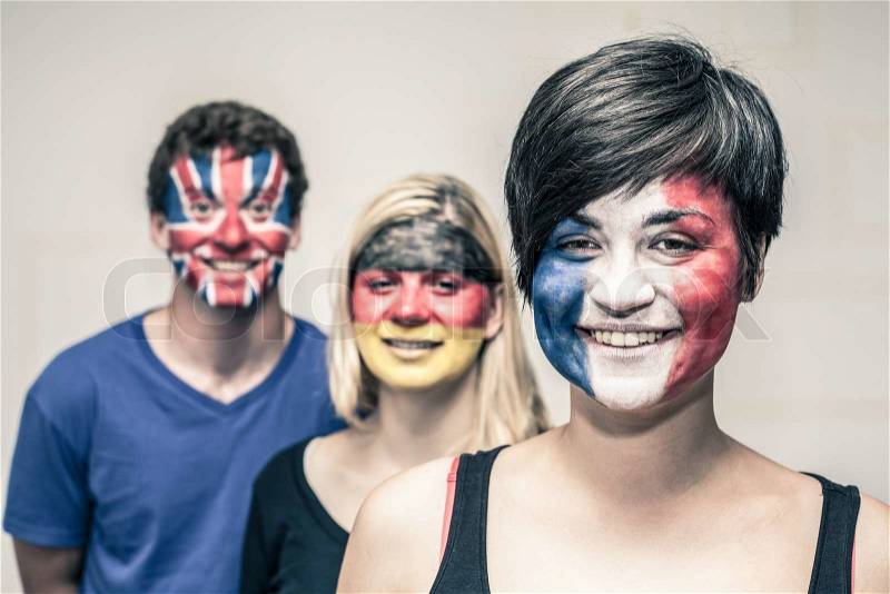 Group of happy people with painted flags on their faces, stock photo