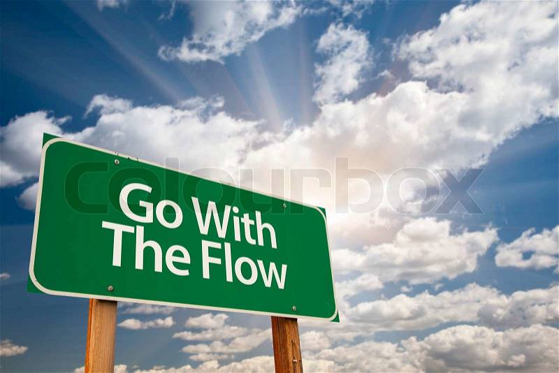 Go With The Flow Green Road Sign with Dramatic Clouds and Sky, stock photo
