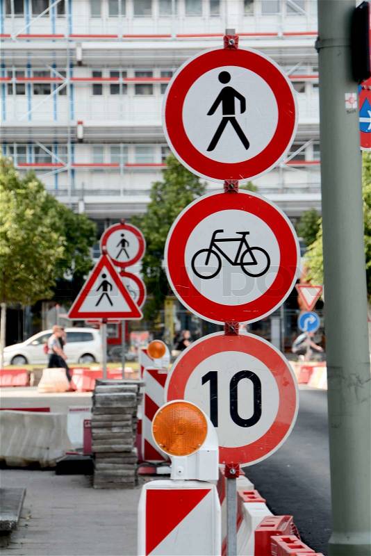 Confusion by many traffic signs on a building site in a street in Berlin, stock photo