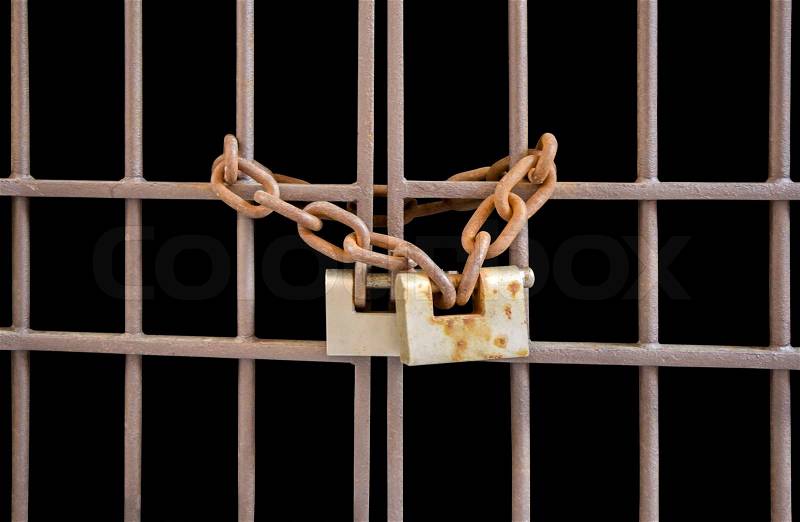 The door of iron bars locked with a chain and padlock , stock photo