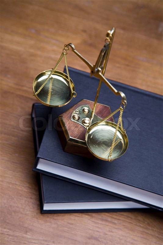 Scales of justice and gavel on desk with dark background, stock photo