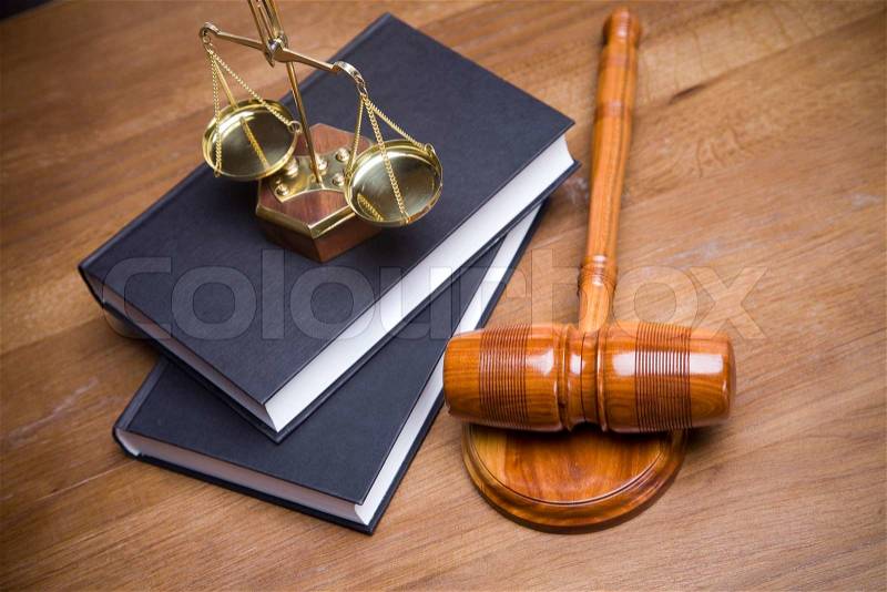 Scales of justice and gavel on desk with dark background, stock photo