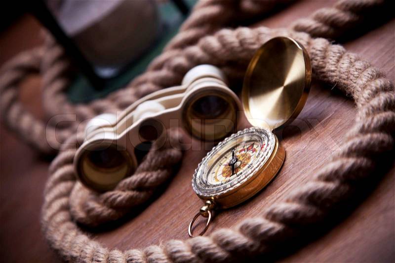 Golden Compass, navigation equipment and rope, stock photo