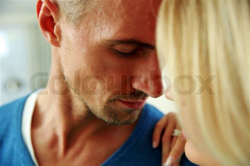 Closeup portrait of a man and a woman face to face with eyes closed, stock photo