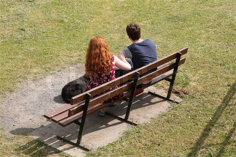 10459608-the-girl-with-red-hair-and-her-boyfriend-sitting-on-the-bench-with-the-dog-in-the-park-in-summertime.jpg