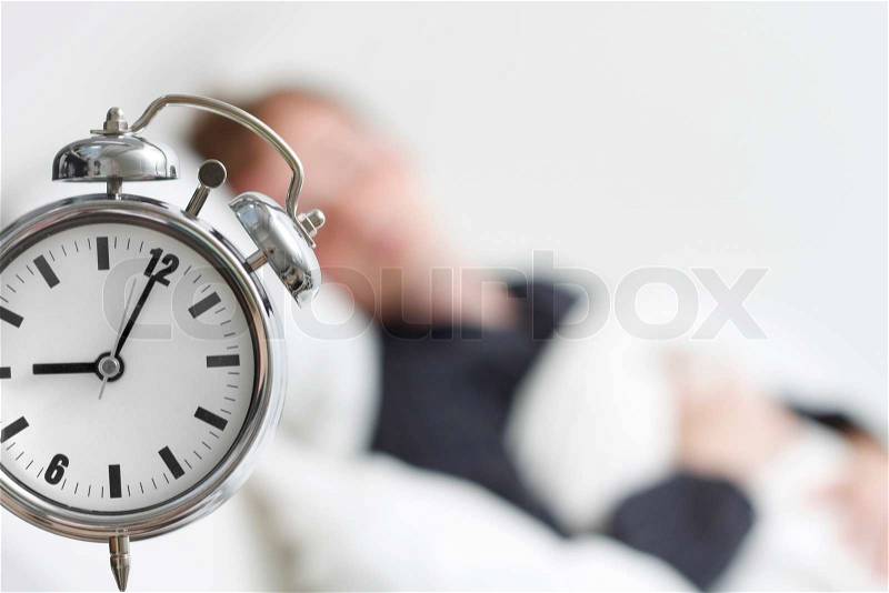 A man who did not hear his alarm clock, stock photo