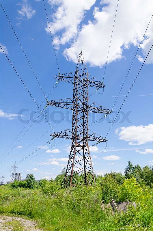 High-voltage power tower over blue sky, stock photo