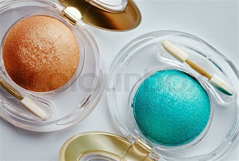 Orange and turquoise powder and brush, top view, stock photo