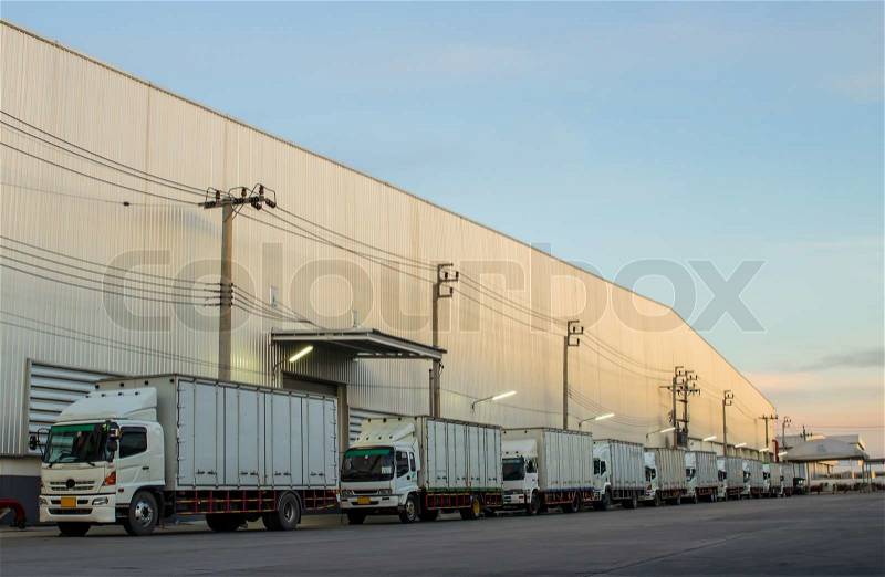 White trucks parked on a parking places in warehouse, stock photo