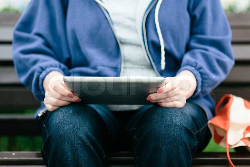 Senior woman with tablet pc on the street, stock photo