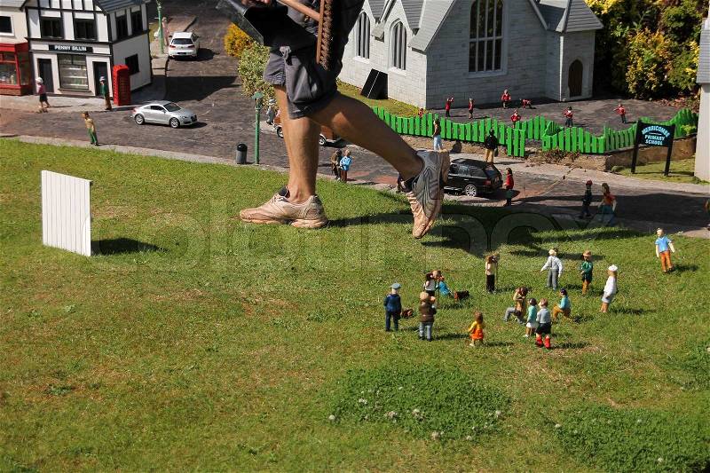 Oh....ooohhh, great steps from the 'giant', the gardener, the mini dolls are scared in mini world in summertime, stock photo