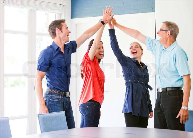 4 business people celebrating an achieved aim, stock photo