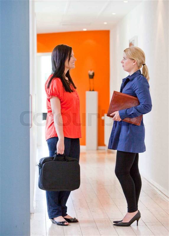 Colleagues meeting at the hallways and talking about the weekend/ work etc, stock photo