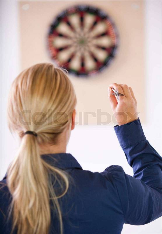 Business people playing dart in a break room at the office. Business people having fun i the break/ recreation room, stock photo