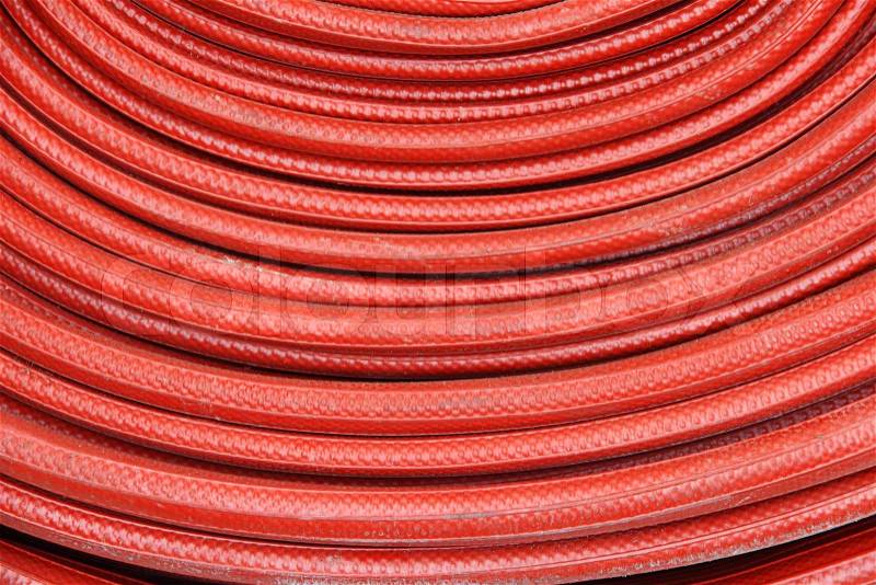 Red fire hose winder through use of firefighters , stock photo