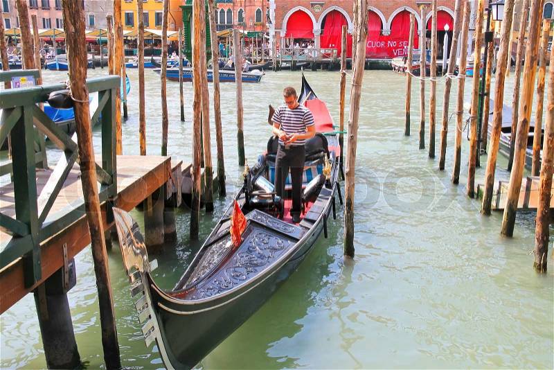 VENICE, ITALY - MAY 06, 2014: Gondolier in a gondola on the Grand Canal in Venice, Italy, stock photo