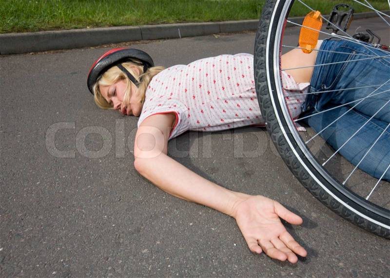 Female hit and and run victim lying on a road, stock photo