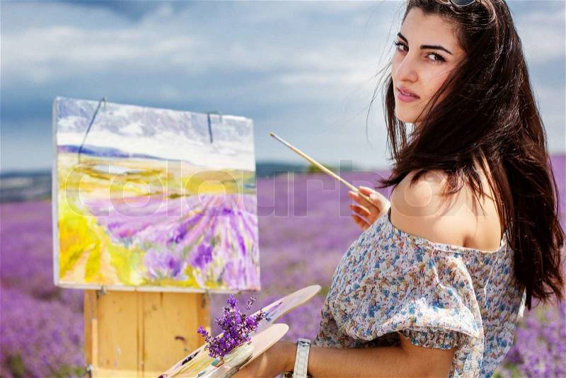 Young artist painting an floral landscape, stock photo