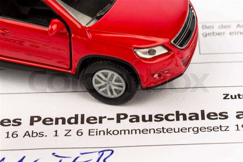 An application for the commuter tax with a red model car, stock photo