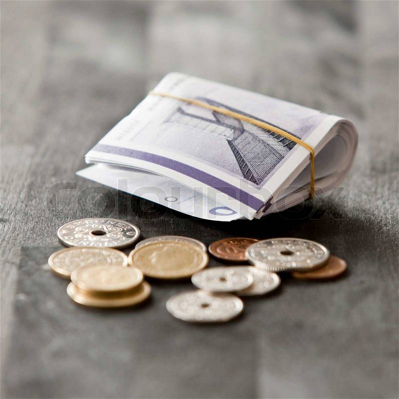 Rolled danish kroners and coins, stock photo