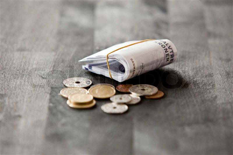 Rolled danish kroners and coins, stock photo