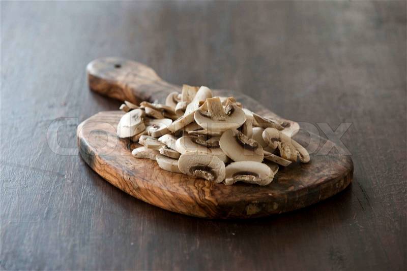 Slices of mushrooms on a chopping board, stock photo