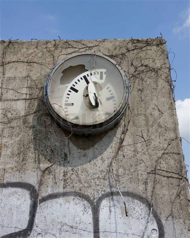 Broken clock on a wall, stock photo