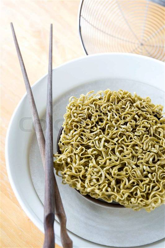 Green vegetable raw noodles on bowl, stock photo