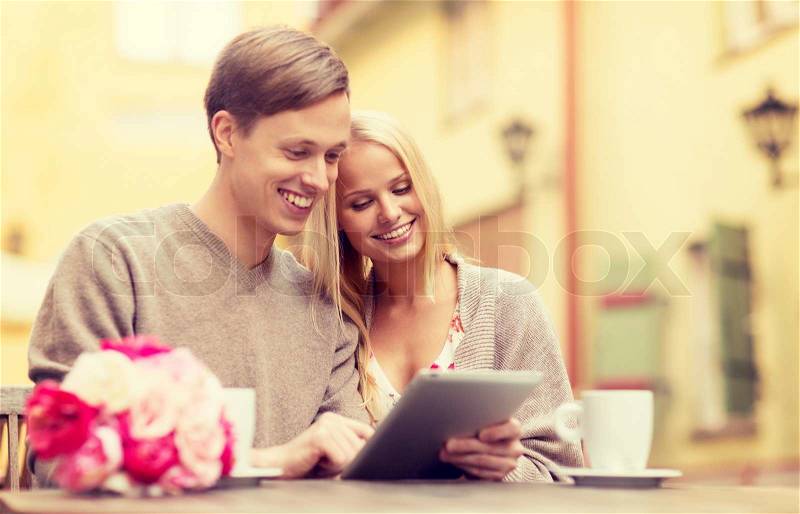 Summer holidays, city, dating and technology concept - couple with tablet pc in cafe, stock photo