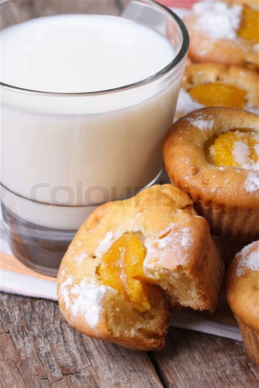Peach muffins and milk closeup on wooden table. vertical , stock photo
