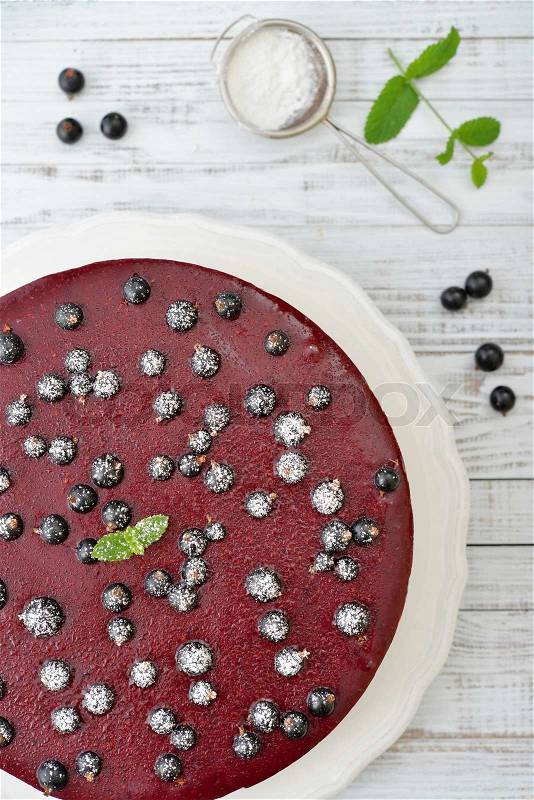 Black currant cheesecake with fresh berries on plate closeup, stock photo