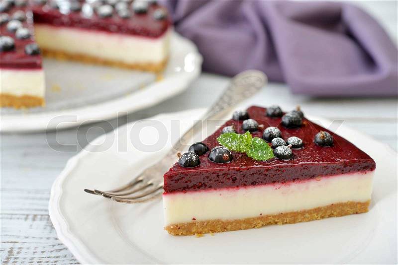 Black currant cheesecake with fresh berries on plate closeup, stock photo