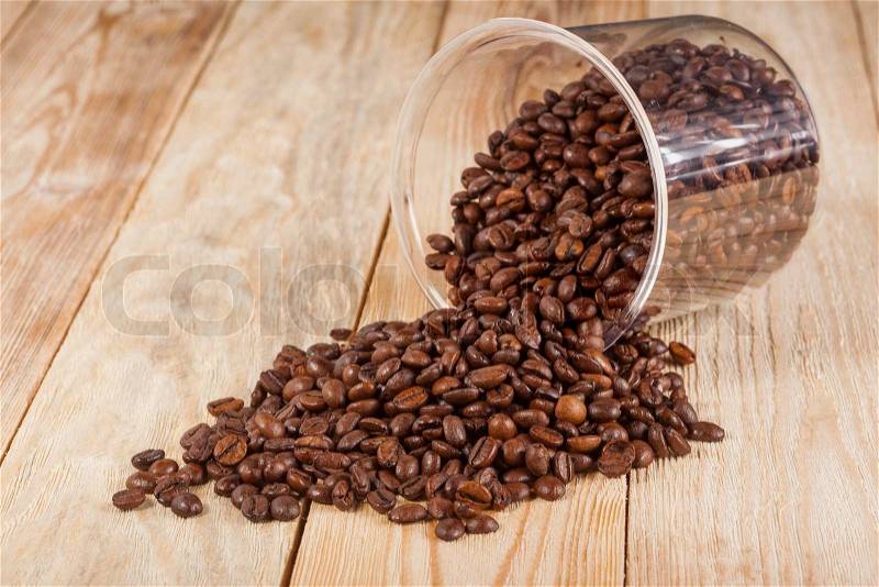 Coffee beans on wooden board, stock photo