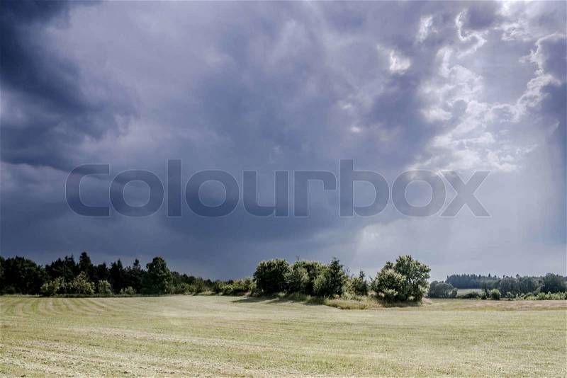 Landscape with dark thunder clouds, stock photo