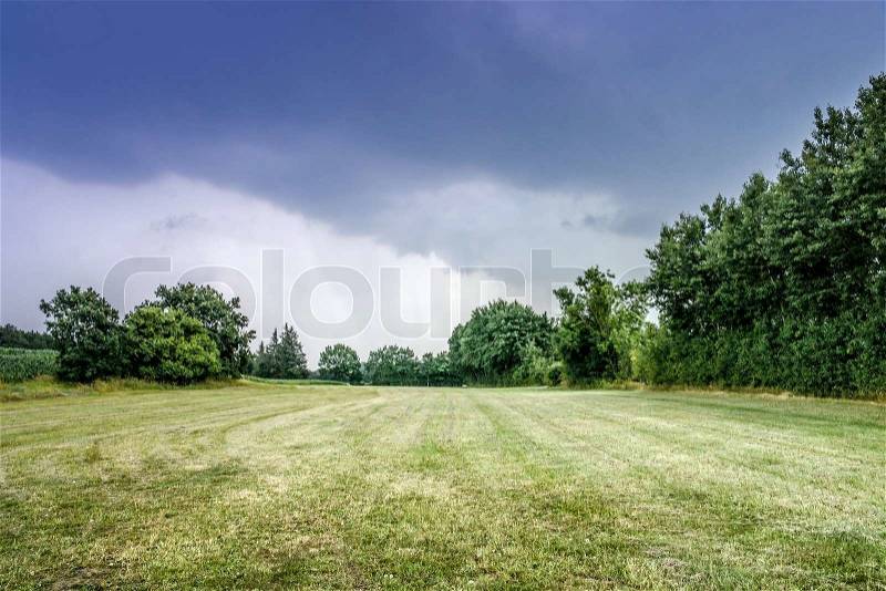 Cloudy weather over a field, stock photo