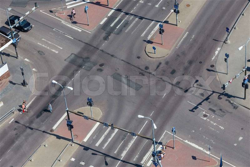 High angle view of an empty street intersection with cross walk markings, traffic signal lights, stock photo