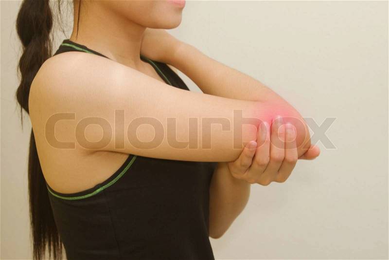 Sports injury ,young woman having pain in her elbow, stock photo