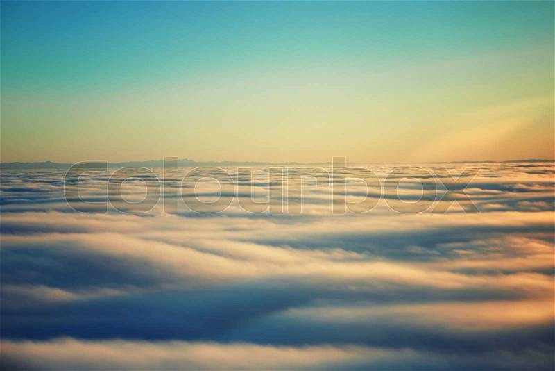 Amazing view from plane on the orange sky, sunset sun and clouds, stock photo