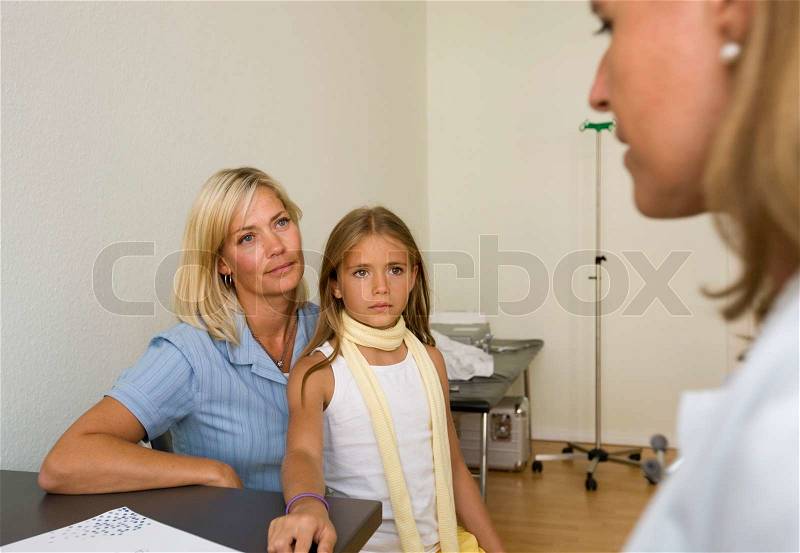 A mother and her daughter consulting a female doctor, stock photo
