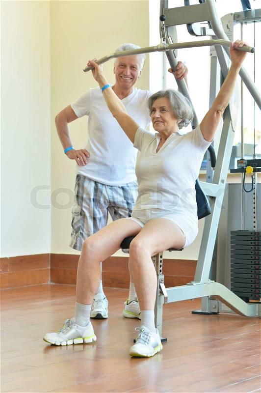 Portrait of beautiful elderly couple in gym, stock photo